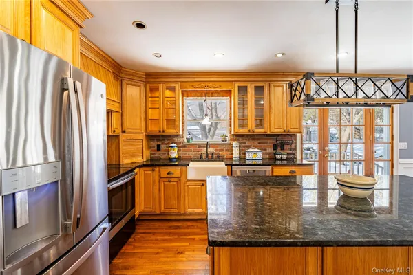 a kitchen with stainless steel appliances granite countertop a stove and a refrigerator