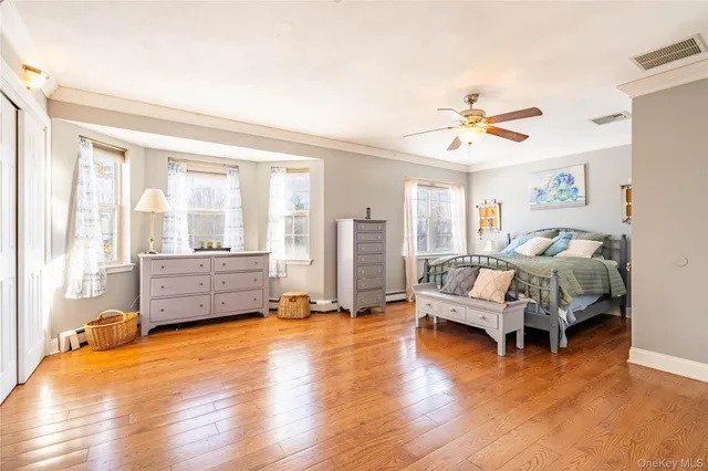 a bedroom with furniture and wooden floor