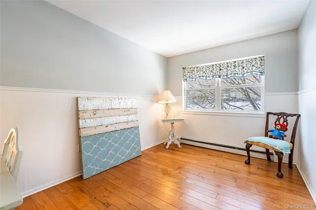 a view of room with window and wooden floor