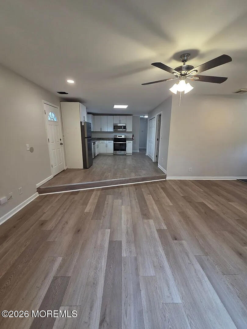 3 Freewood Street Howell, NJ 07731 - Photo 3 of 9 a view of a livingroom with a ceiling fan & wooden floor