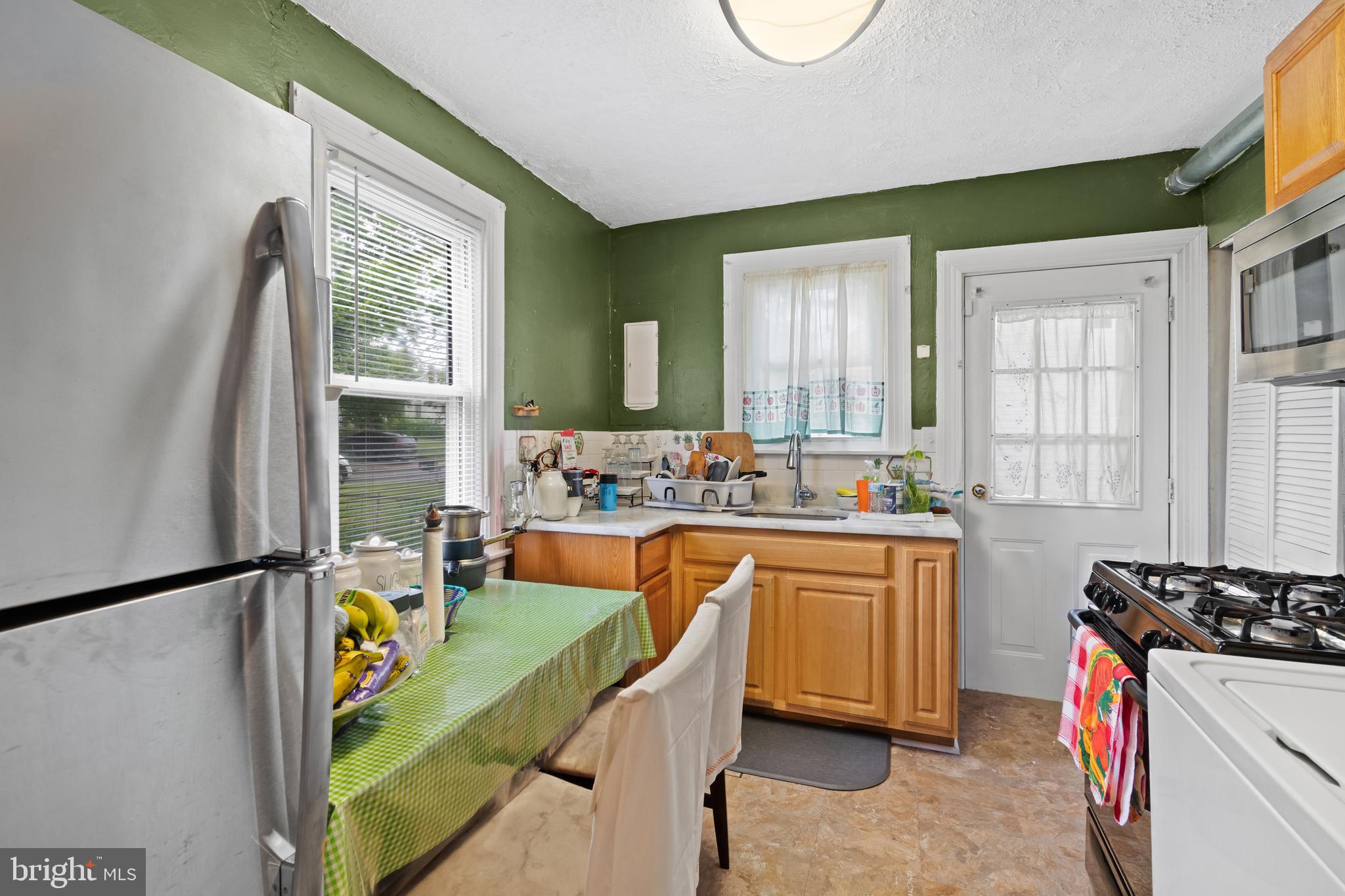 4410 Allies Road Suitland, MD 20746 - Photo 11 of 30 a kitchen with stainless steel appliances granite countertop sink stove and refrigerator