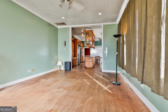 a view of entryway and hall with wooden floor