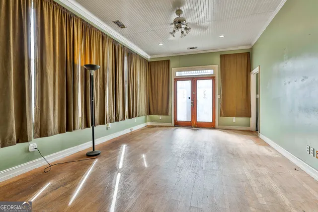 a view of a hallway with wooden floor and staircase