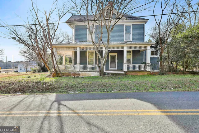 a front view of a residential apartment building with a yard
