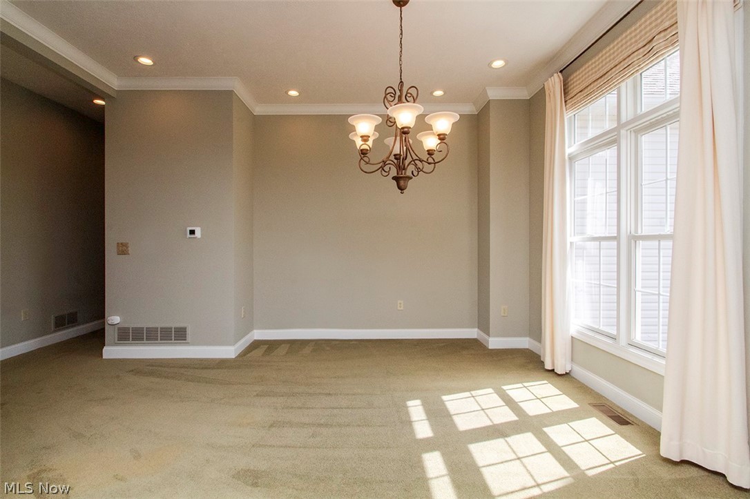 2201 Granger Road Medina, OH 44256 - Photo 6 of 34 Dining room with suspended lighting, light carpet, and crown molding