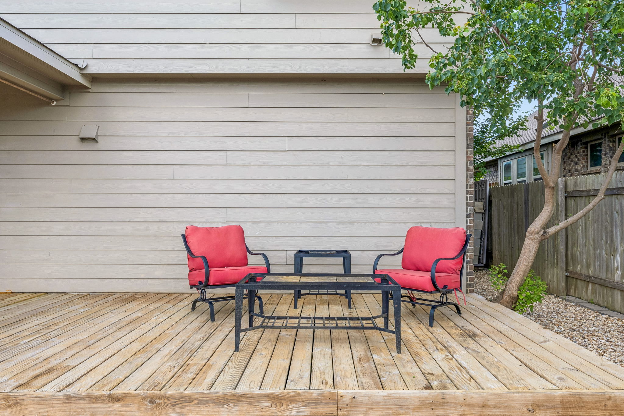 689 Nautical Loop Kyle, TX 78640 - Photo 32 of 34 A spacious wooden deck provides an inviting outdoor lounging space for relaxation.