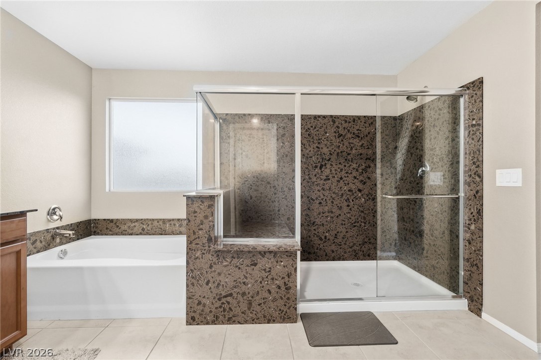 150 Fulgora Street Henderson, NV 89074 - Photo 48 of 92 Bathroom with a garden tub, a stall shower and light tile patterned floors