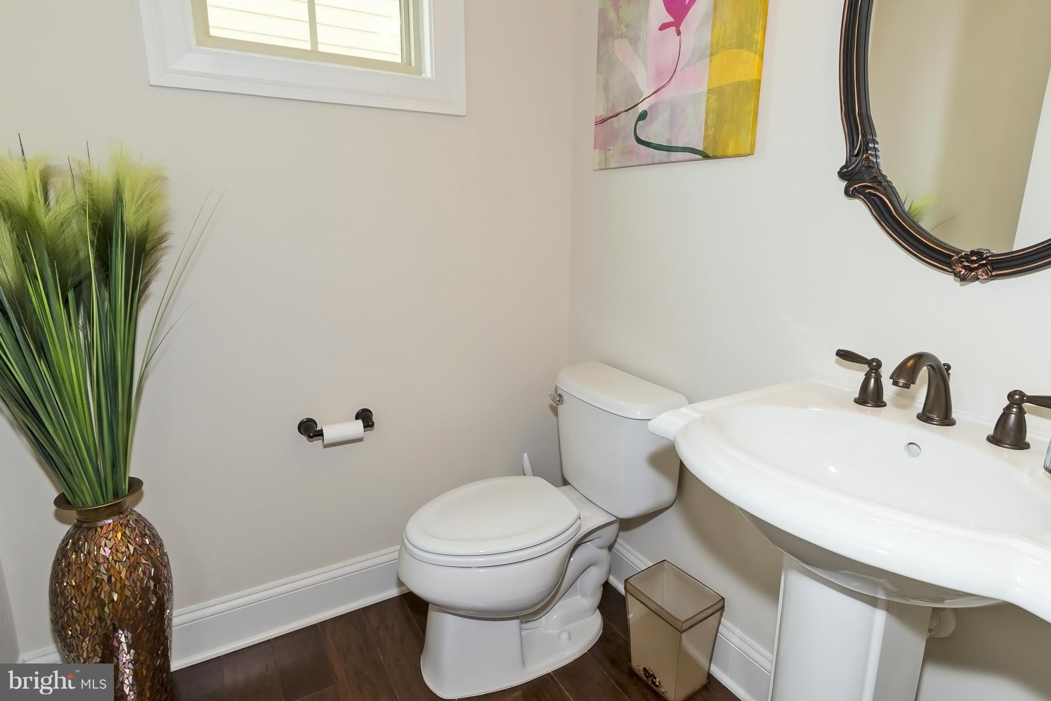 7733 Elmwood Road Fulton, MD 20759 - Photo 13 of 30 a white toilet sitting next to a bathroom sink