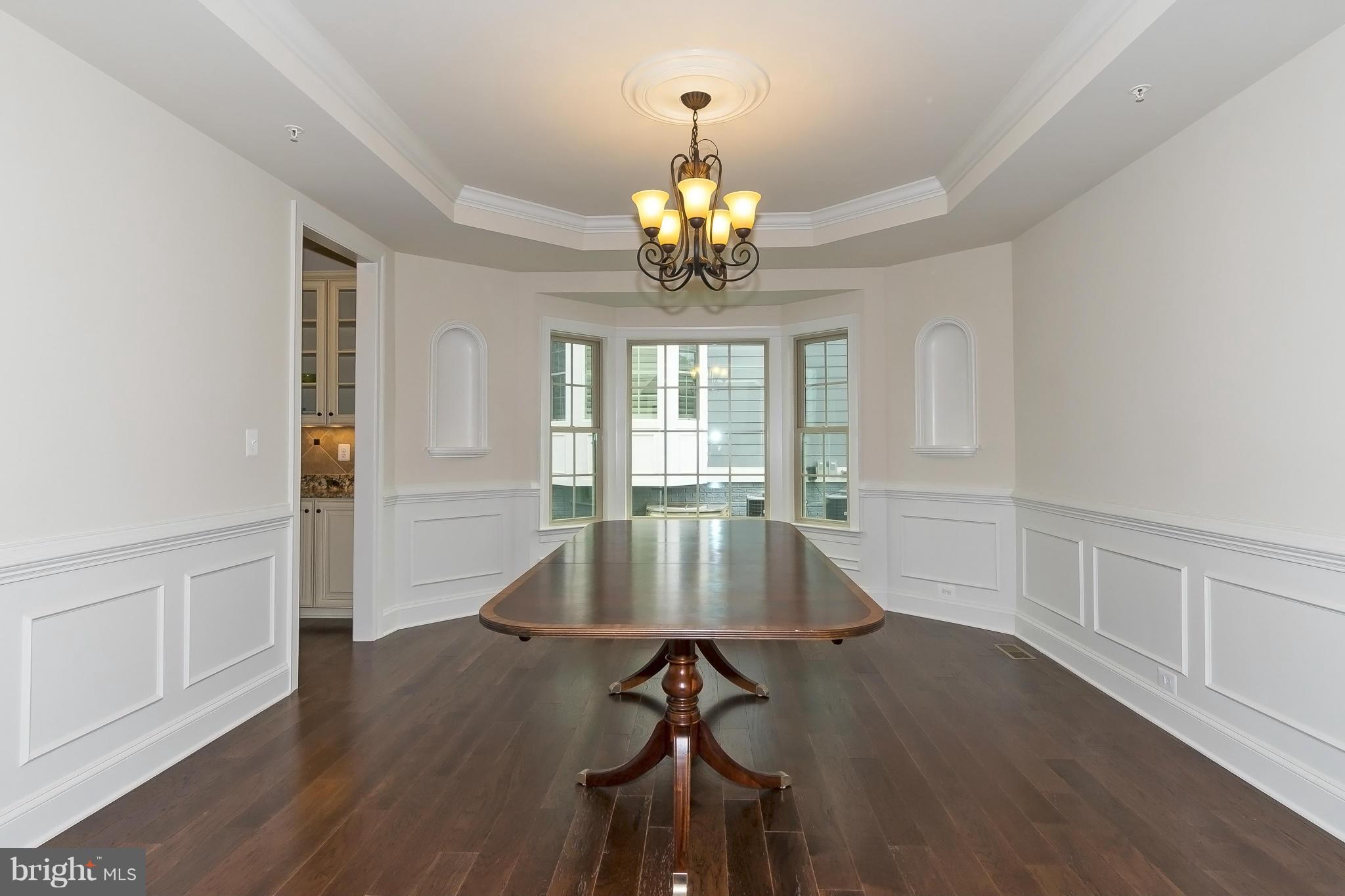 7733 Elmwood Road Fulton, MD 20759 - Photo 3 of 30 a view of a dining room with furniture wooden floor and chandelier