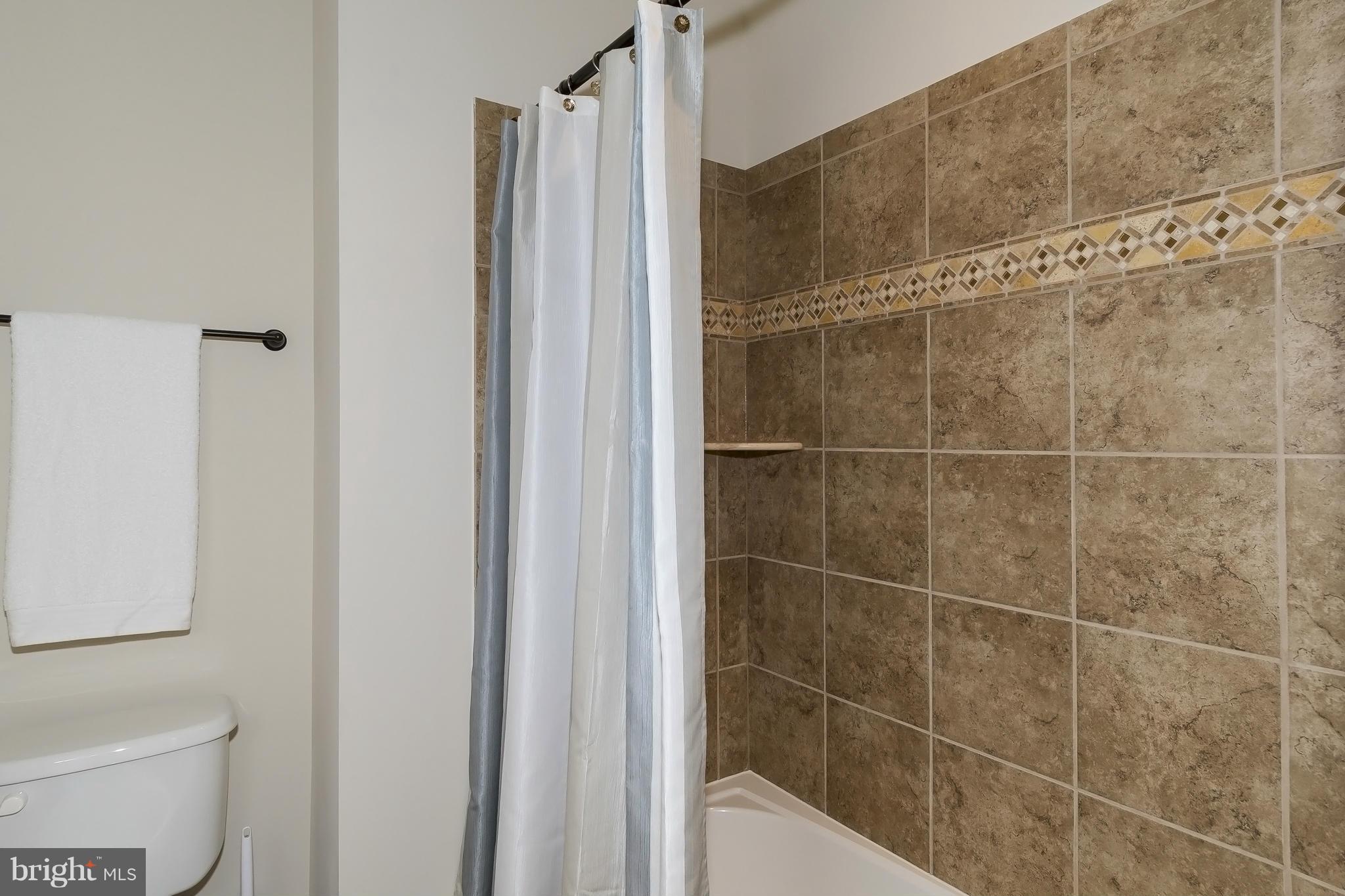 7733 Elmwood Road Fulton, MD 20759 - Photo 22 of 30 a bathroom with a shower and a toilet