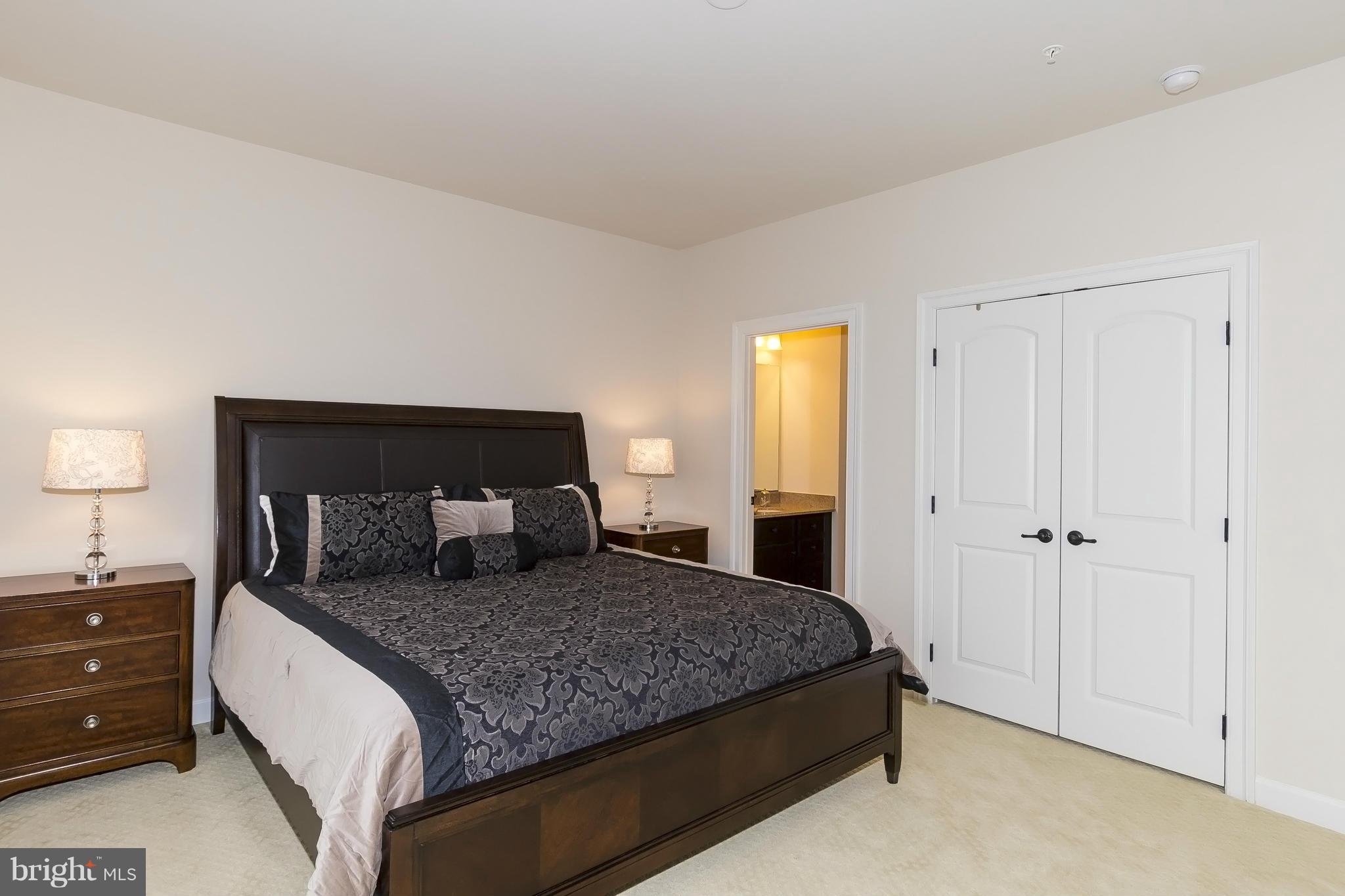 7733 Elmwood Road Fulton, MD 20759 - Photo 23 of 30 a bedroom with a large bed and a dresser