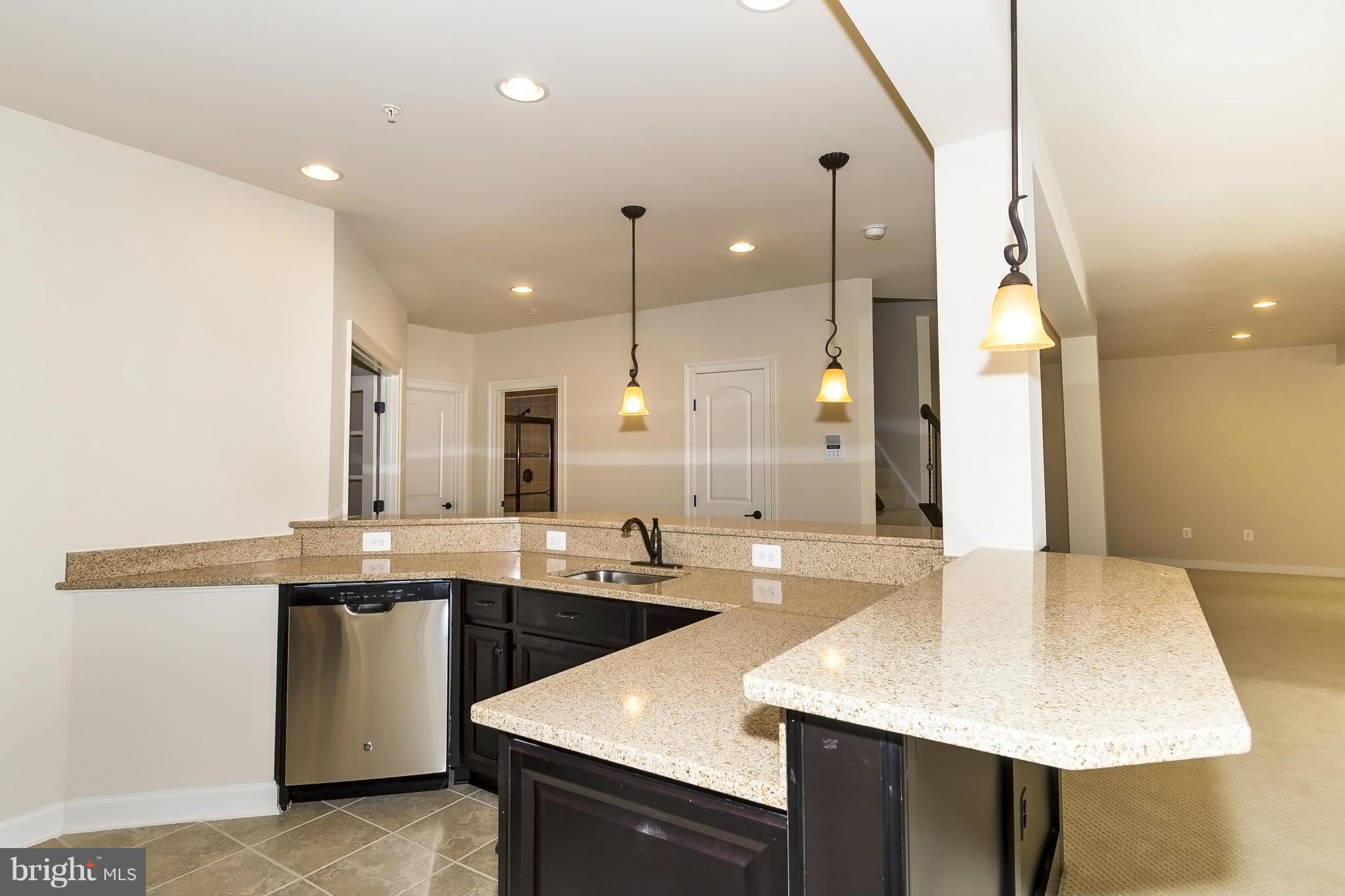 7733 Elmwood Road Fulton, MD 20759 - Photo 26 of 30 a kitchen with stainless steel appliances granite countertop a sink a stove and a refrigerator