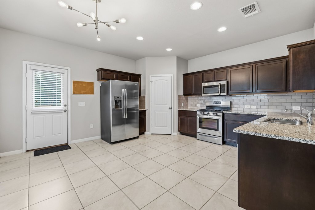 6517 Ranchito Drive Austin, TX 78744 - Photo 11 of 36 Kitchen & Dining Space with clean finishes and efficient design