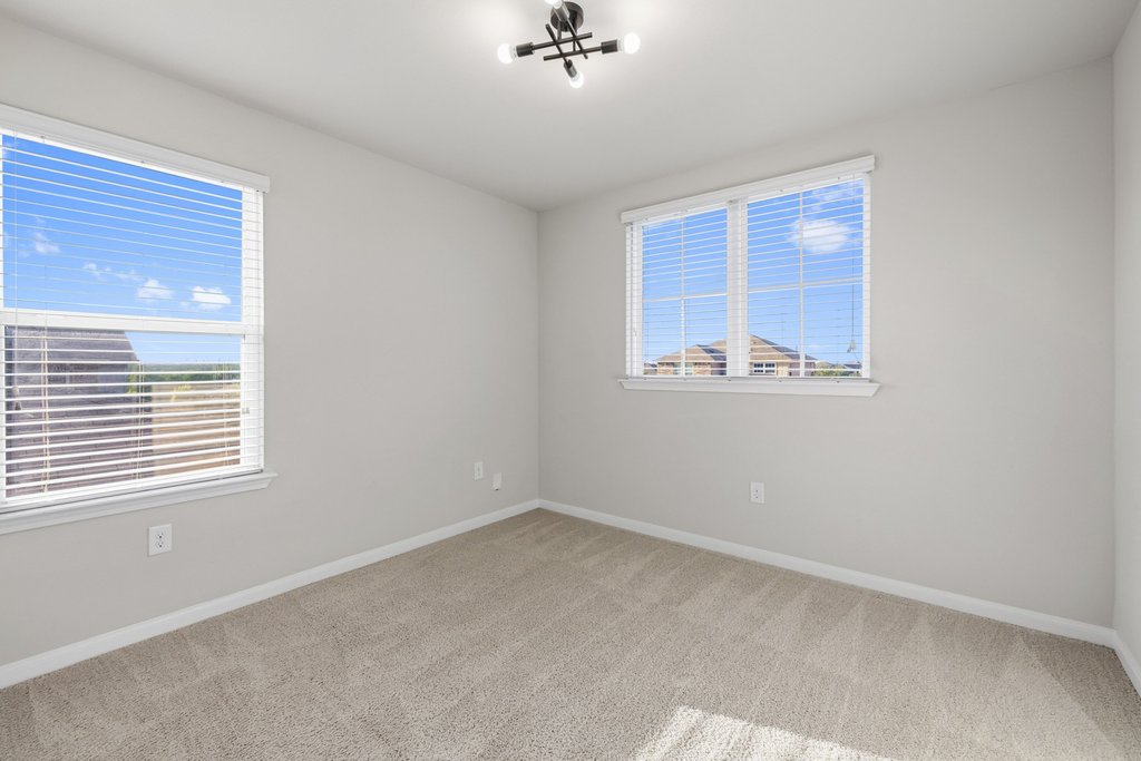 6517 Ranchito Drive Austin, TX 78744 - Photo 23 of 36 Upstairs bedroom with plenty of natural light