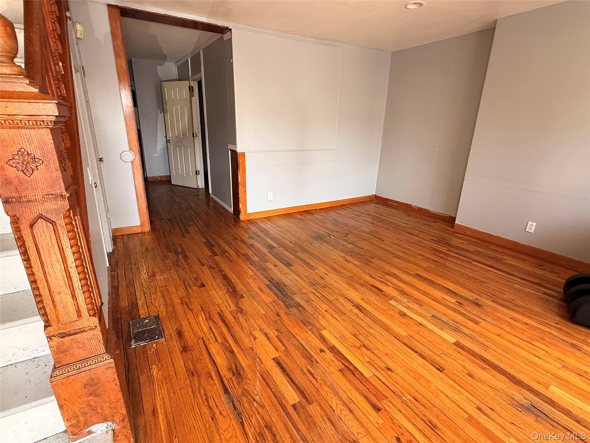 88-25 75th Street Queens, NY 11421 - Photo 2 of 8 wooden floor in an empty room