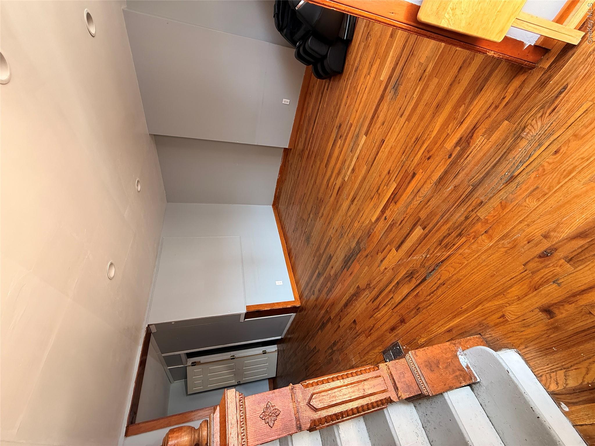 88-25 75th Street Queens, NY 11421 - Photo 3 of 8 a bedroom with a bed and a mirror