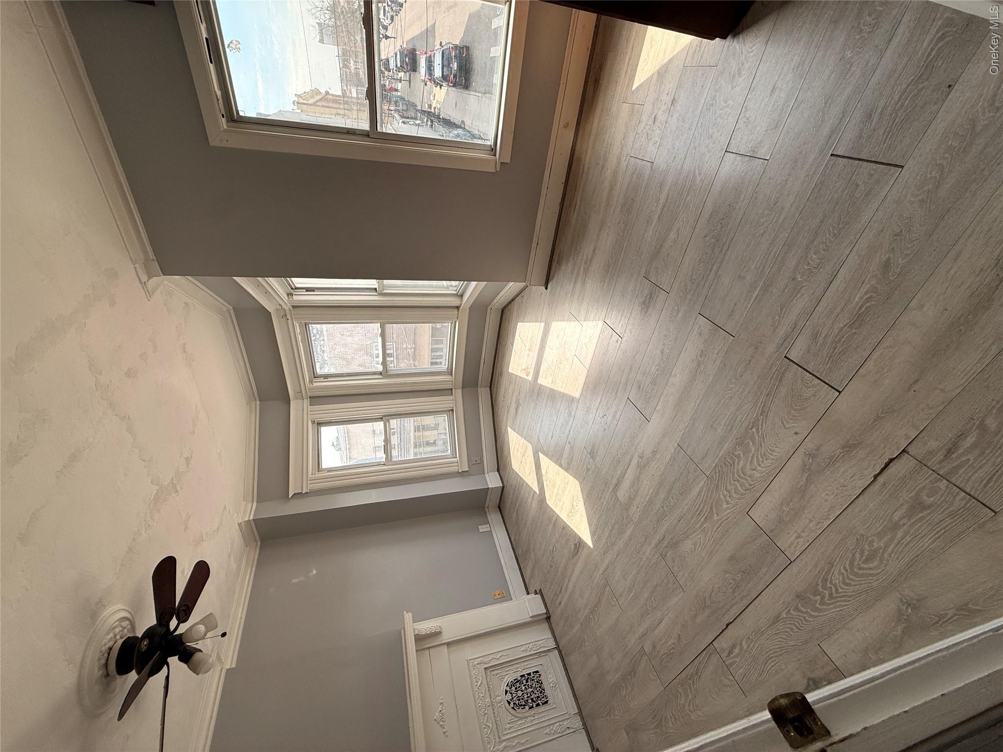 88-25 75th Street Queens, NY 11421 - Photo 5 of 8 a view of an empty room with a window
