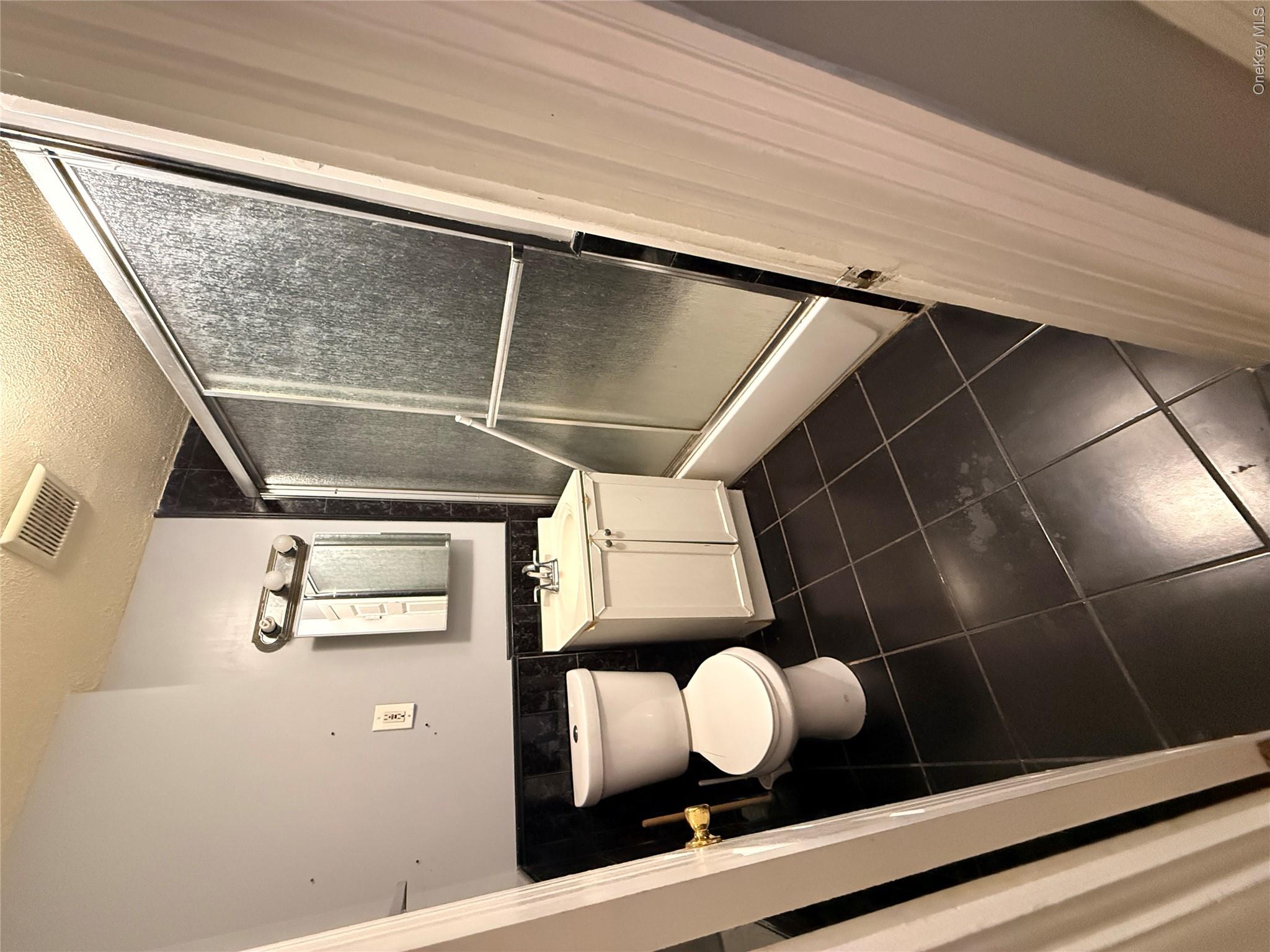 88-25 75th Street Queens, NY 11421 - Photo 6 of 8 a bathroom with a toilet and a sink