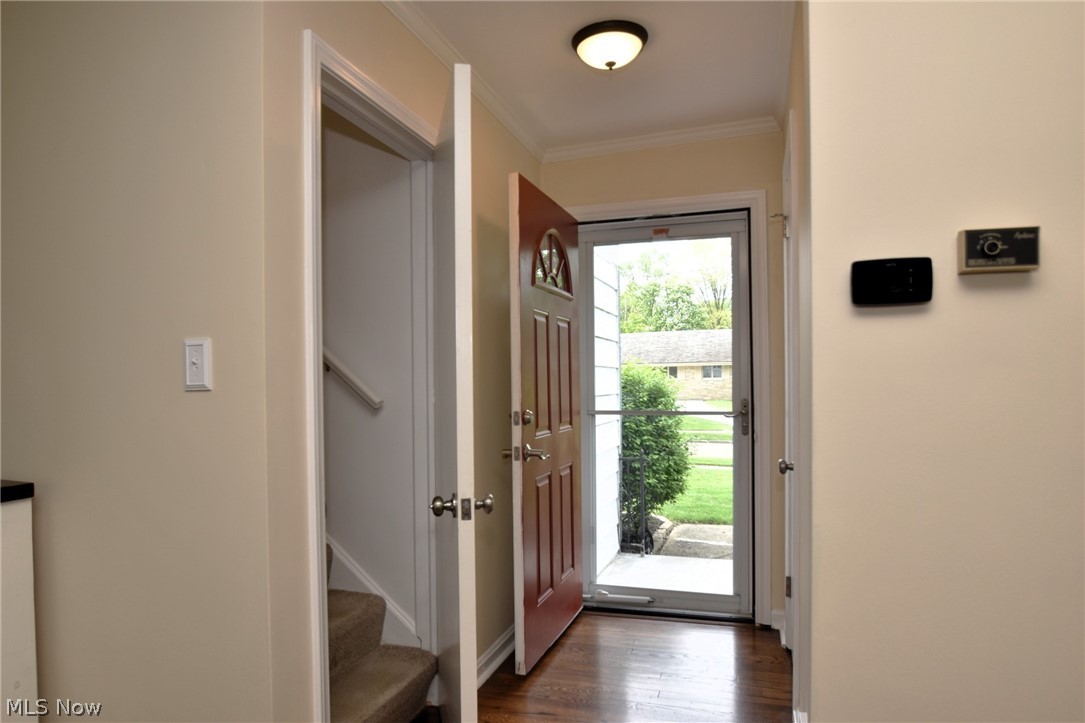 23901 Hazelmere Road Shaker Heights, OH 44122 - Photo 2 of 35 Entrance foyer featuring a healthy amount of sunlight, dark hardwood / wood-style floors, and crown molding