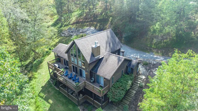 a view of a house with a yard and sitting area