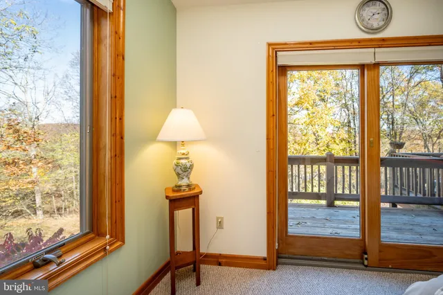 a view of a dining room with furniture a chandelier and wooden floor
