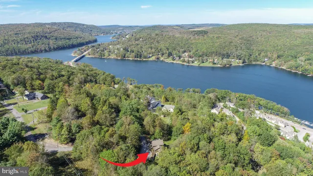 a large kitchen with stainless steel appliances granite countertop a stove and a view of living room