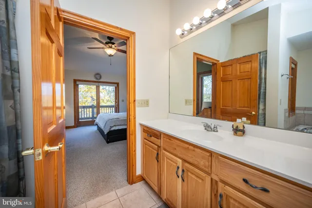a living room with furniture a ceiling fan and a fireplace