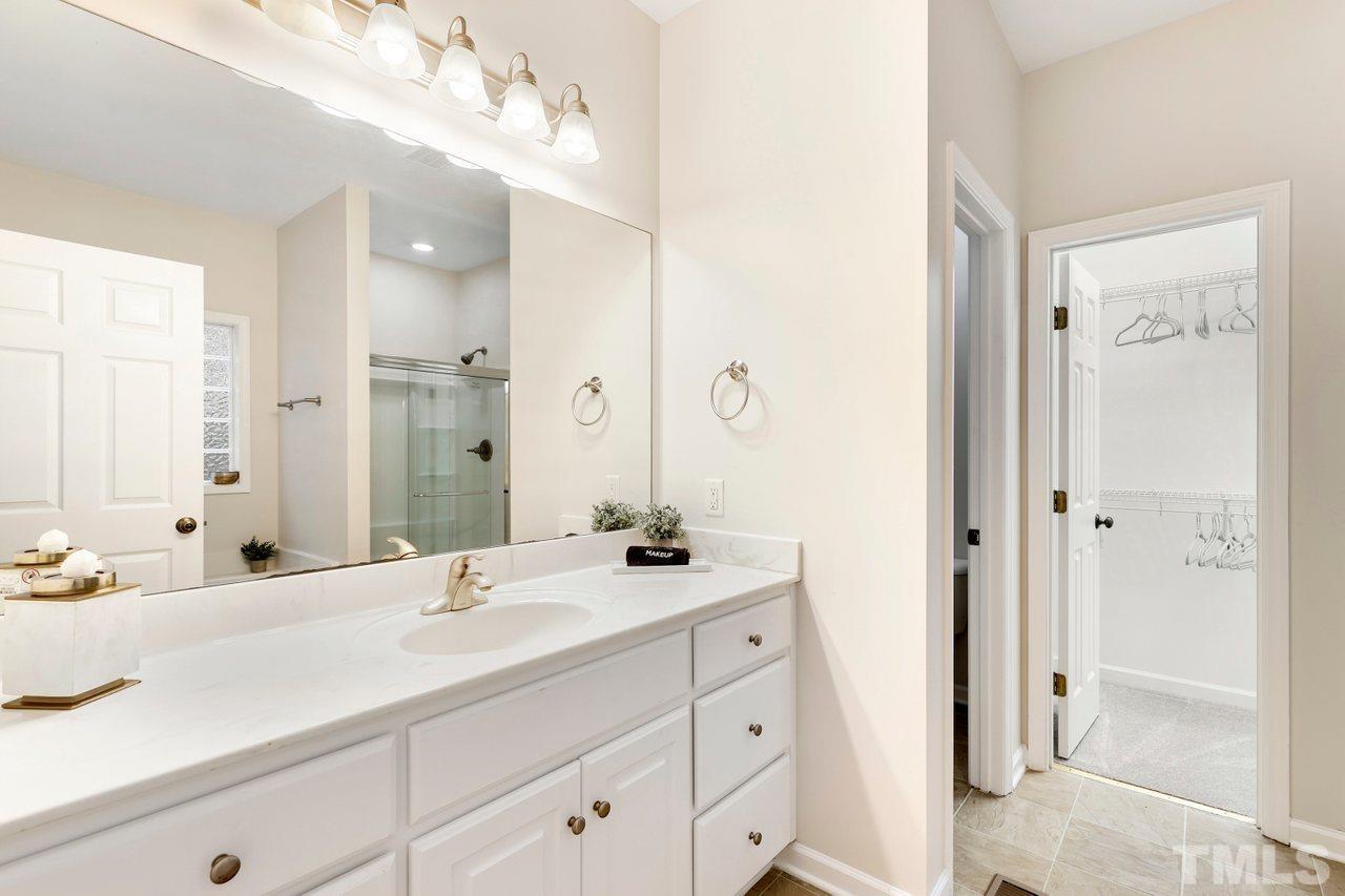 7015 Cedar Road Sanford, NC 27332 - Photo 13 of 30 a bathroom with a shower sink double and mirror