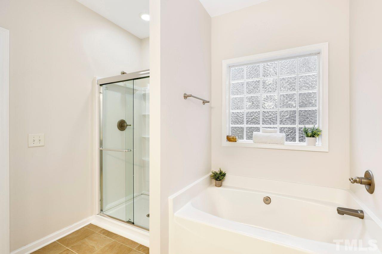 7015 Cedar Road Sanford, NC 27332 - Photo 14 of 30 a white bath tub sitting next to a shower