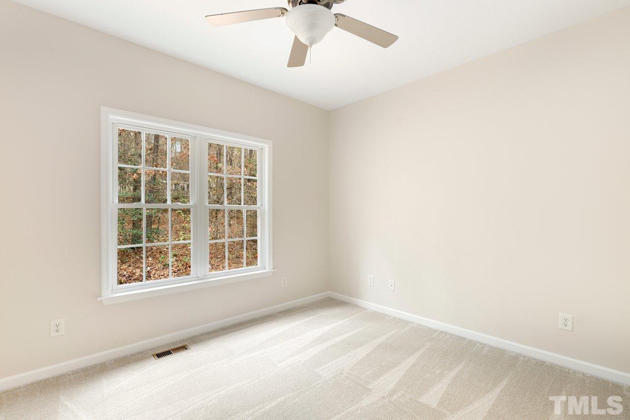 7015 Cedar Road Sanford, NC 27332 - Photo 18 of 30 an empty room with a window and a ceiling fan