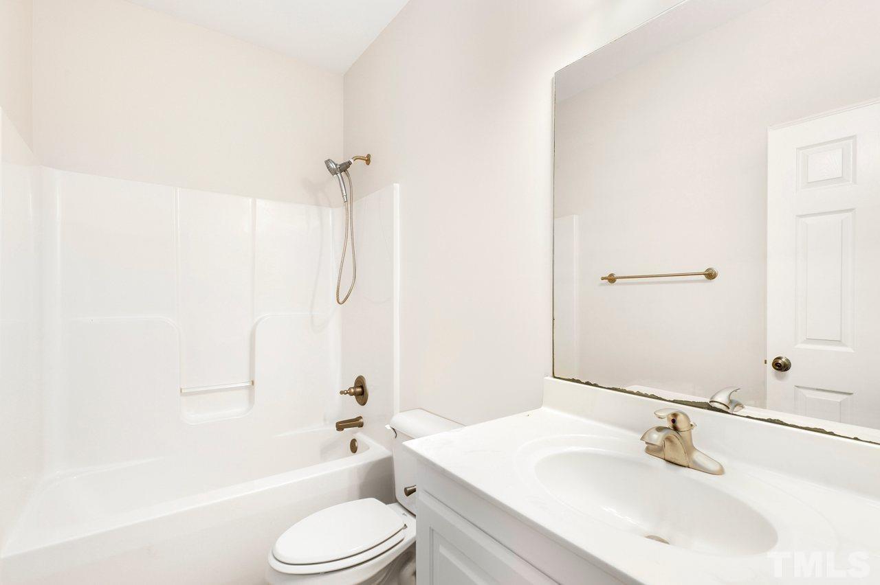 7015 Cedar Road Sanford, NC 27332 - Photo 20 of 30 a bathroom with a sink toilet and shower