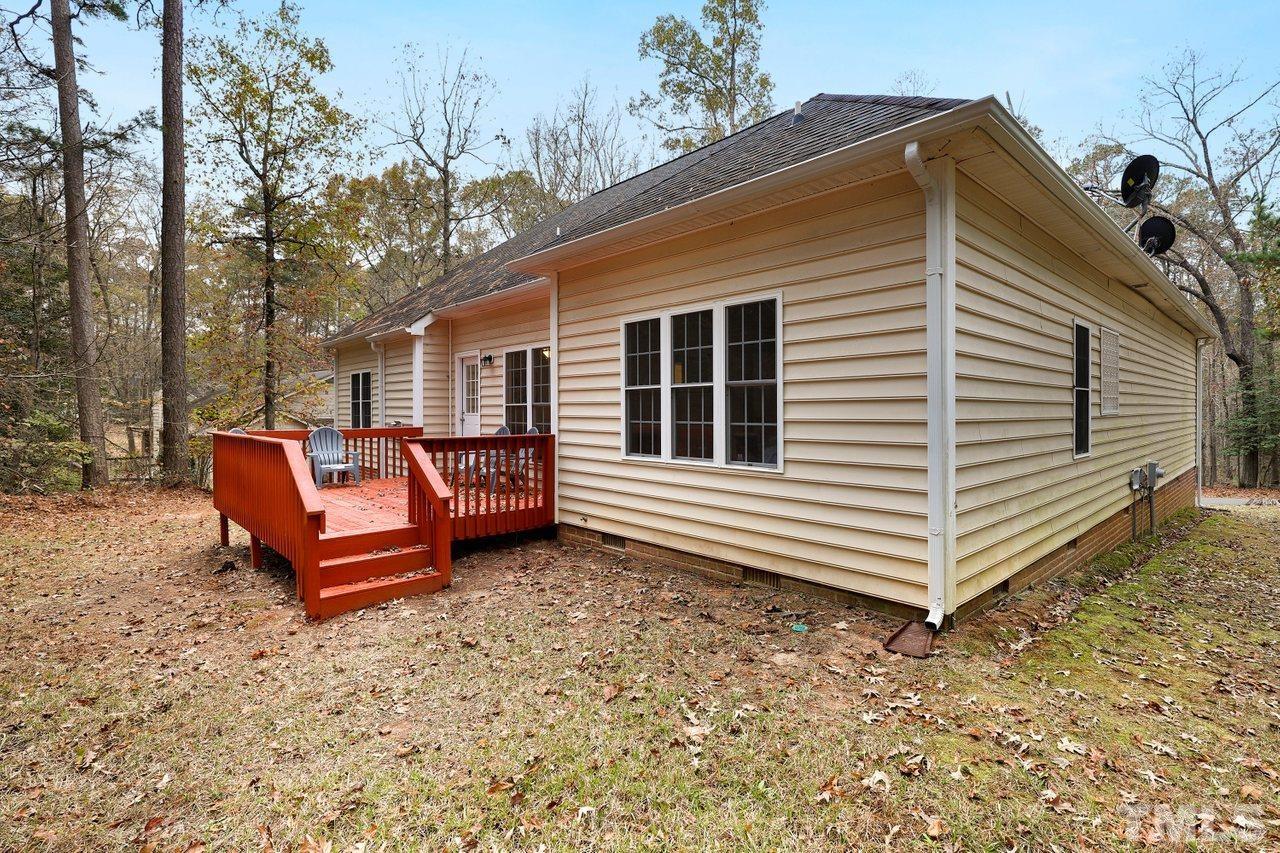 7015 Cedar Road Sanford, NC 27332 - Photo 25 of 30 a backyard of a house with barbeque oven and wooden fence