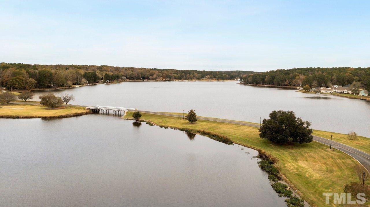 7015 Cedar Road Sanford, NC 27332 - Photo 29 of 30 a view of a lake with houses in the back