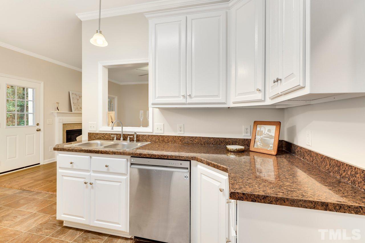 7015 Cedar Road Sanford, NC 27332 - Photo 6 of 30 a kitchen with granite countertop white cabinets and a sink