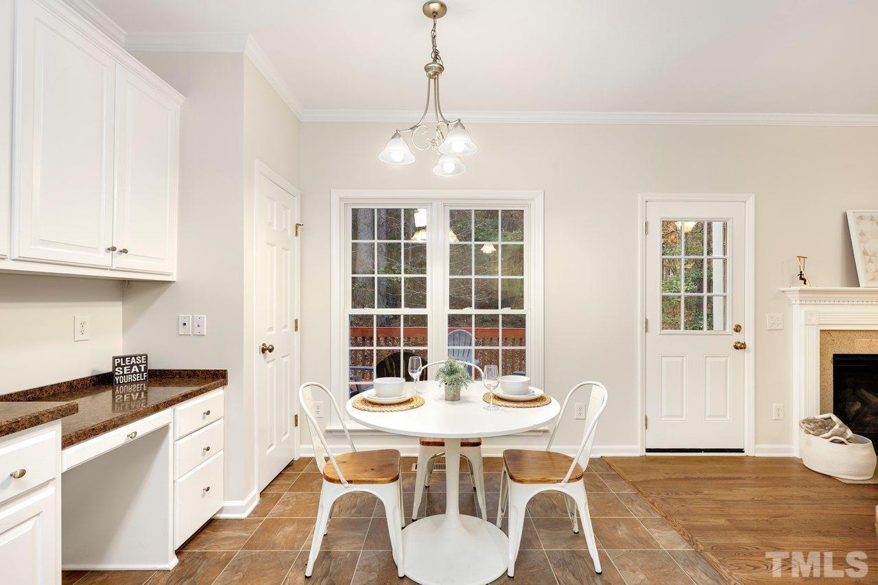 7015 Cedar Road Sanford, NC 27332 - Photo 8 of 30 a kitchen with stainless steel appliances granite countertop a stove a sink a refrigerator dining table and chairs