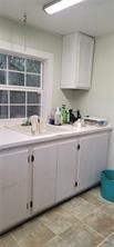 496 Romona Road Seadrift, TX 77983 - Photo 16 of 35 a kitchen with granite countertop white cabinets and a sink