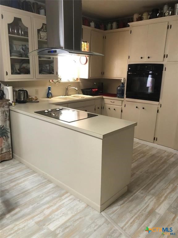 496 Romona Road Seadrift, TX 77983 - Photo 5 of 35 a kitchen with stainless steel appliances a stove a sink and a microwave