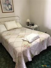 496 Romona Road Seadrift, TX 77983 - Photo 8 of 35 a bedroom with a bed and a painting on the wall