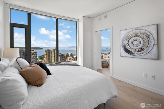 a bedroom with a large bed and a large window