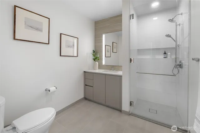 a bathroom with a toilet sink and shower