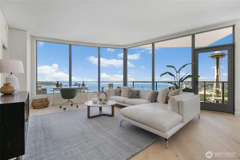 a living room with furniture and large windows