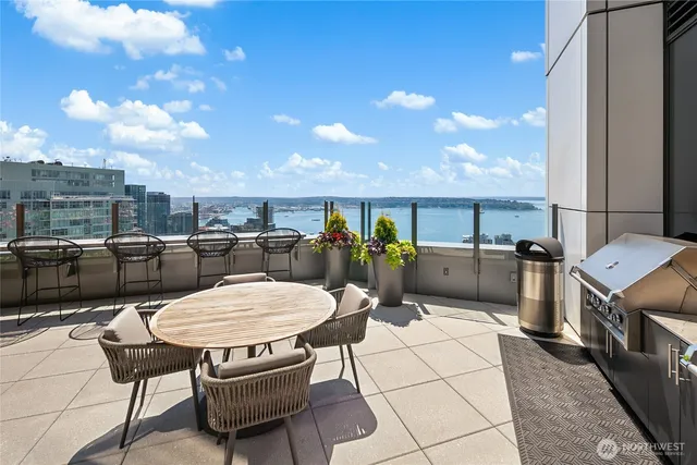 a view of a patio with table and chairs