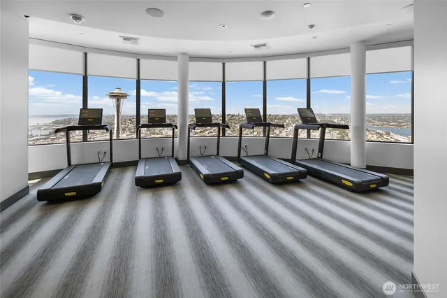 a room with gym equipment and floor to ceiling window