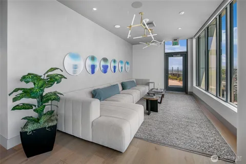 a living room with furniture and a potted plant