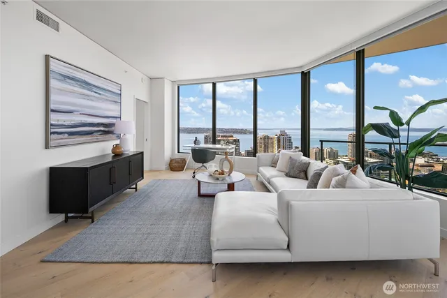 a living room with furniture and large windows