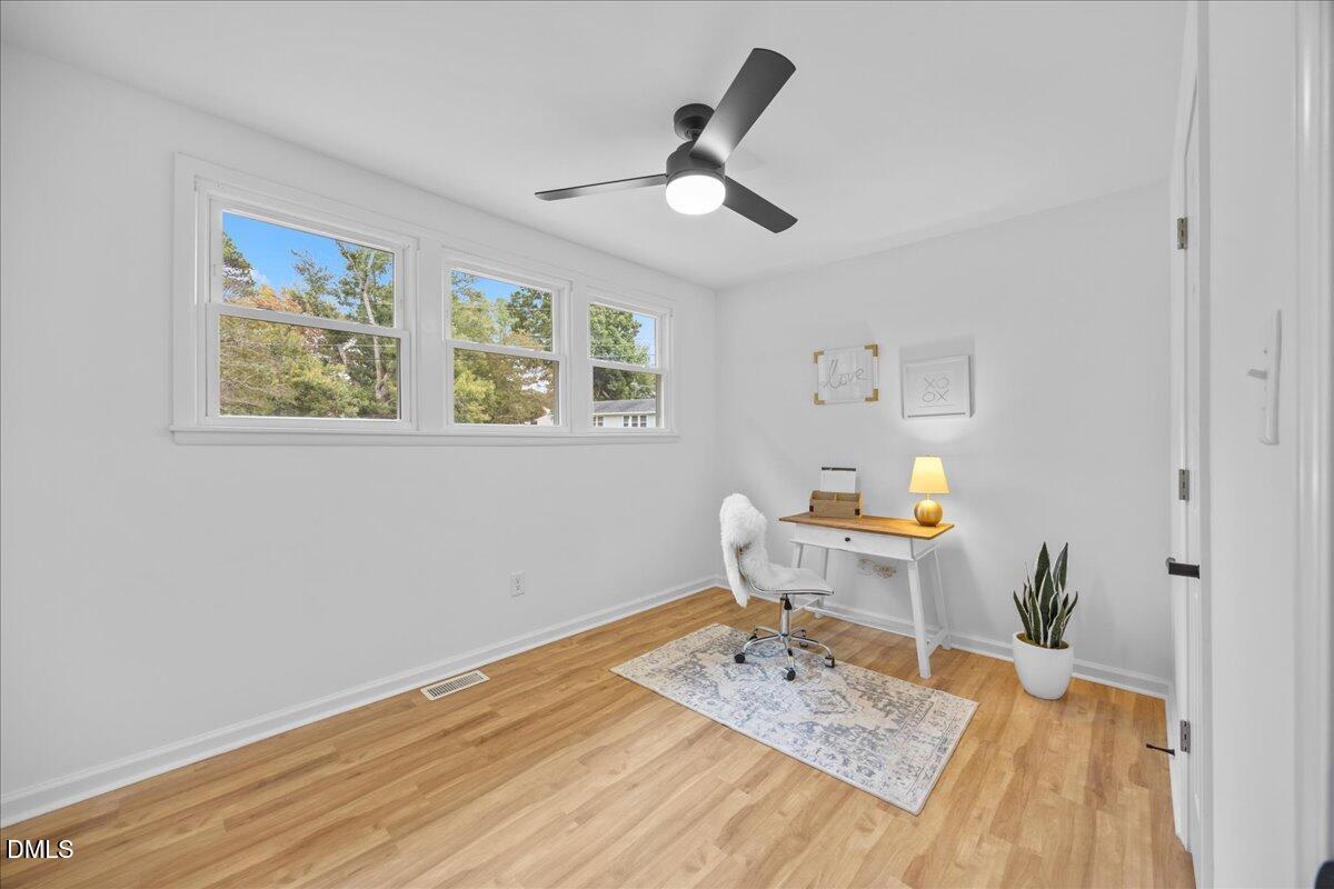 3437 Apache Drive Raleigh, NC 27609 - Photo 22 of 33 a work room with wooden floor furniture and a window