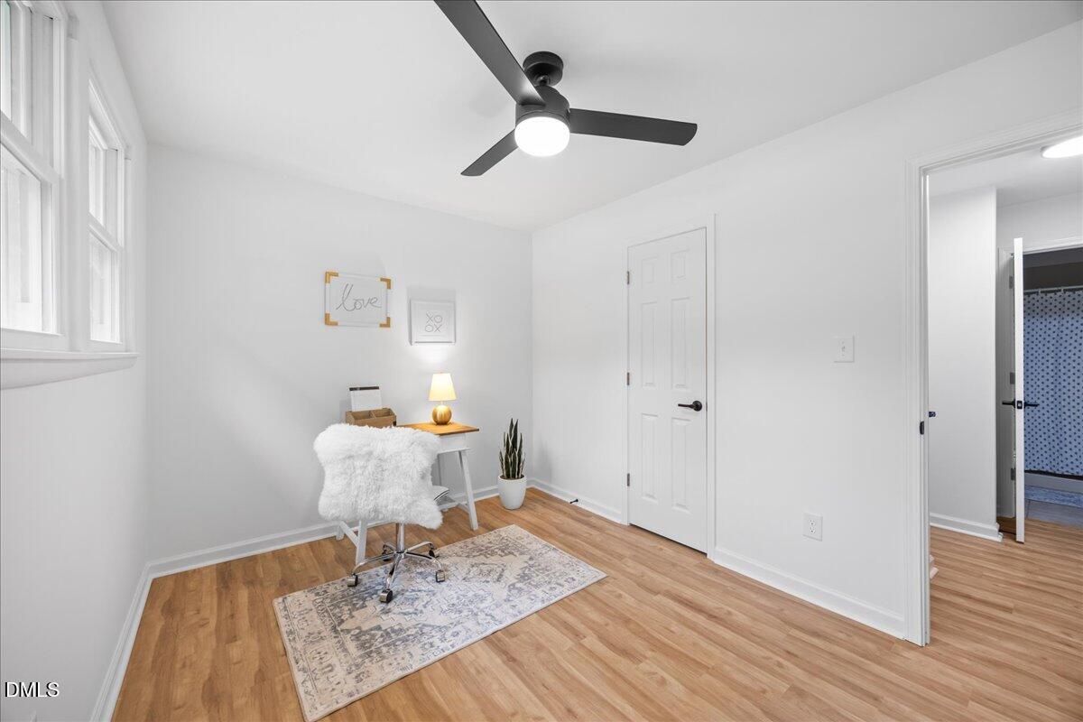 3437 Apache Drive Raleigh, NC 27609 - Photo 23 of 33 a bedroom with a bed and a chandelier fan
