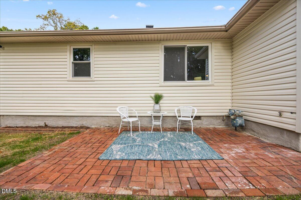 3437 Apache Drive Raleigh, NC 27609 - Photo 24 of 33 a backyard of a house with yard and outdoor seating