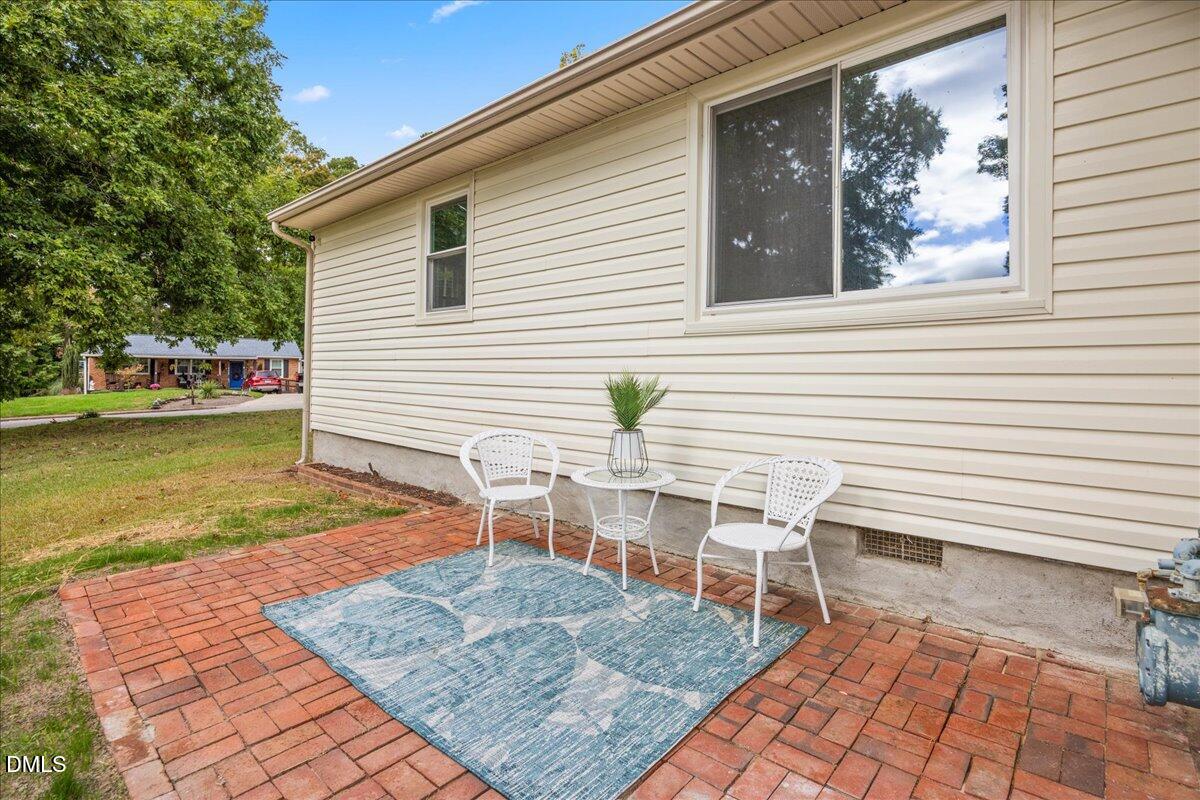 3437 Apache Drive Raleigh, NC 27609 - Photo 25 of 33 a view of a patio with table and chairs with wooden floor and fence