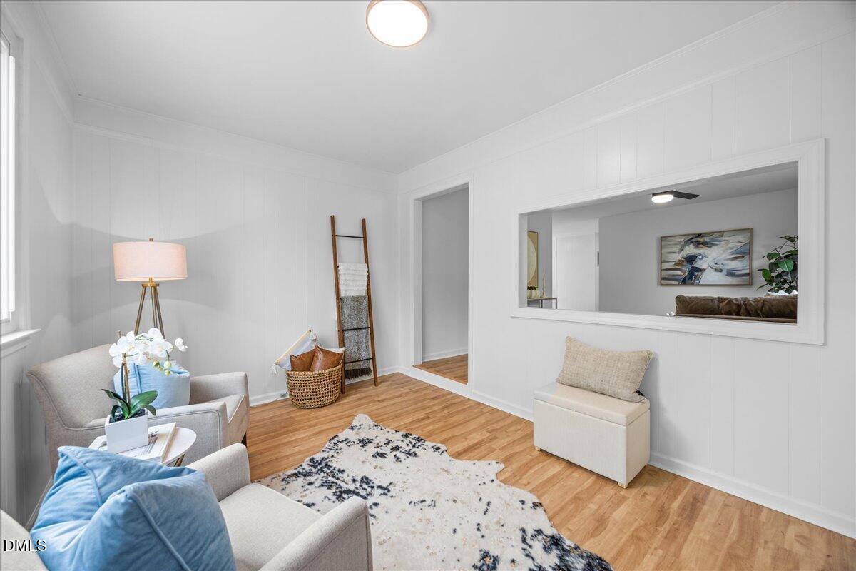 3437 Apache Drive Raleigh, NC 27609 - Photo 3 of 33 a bedroom with a bed and wooden floor